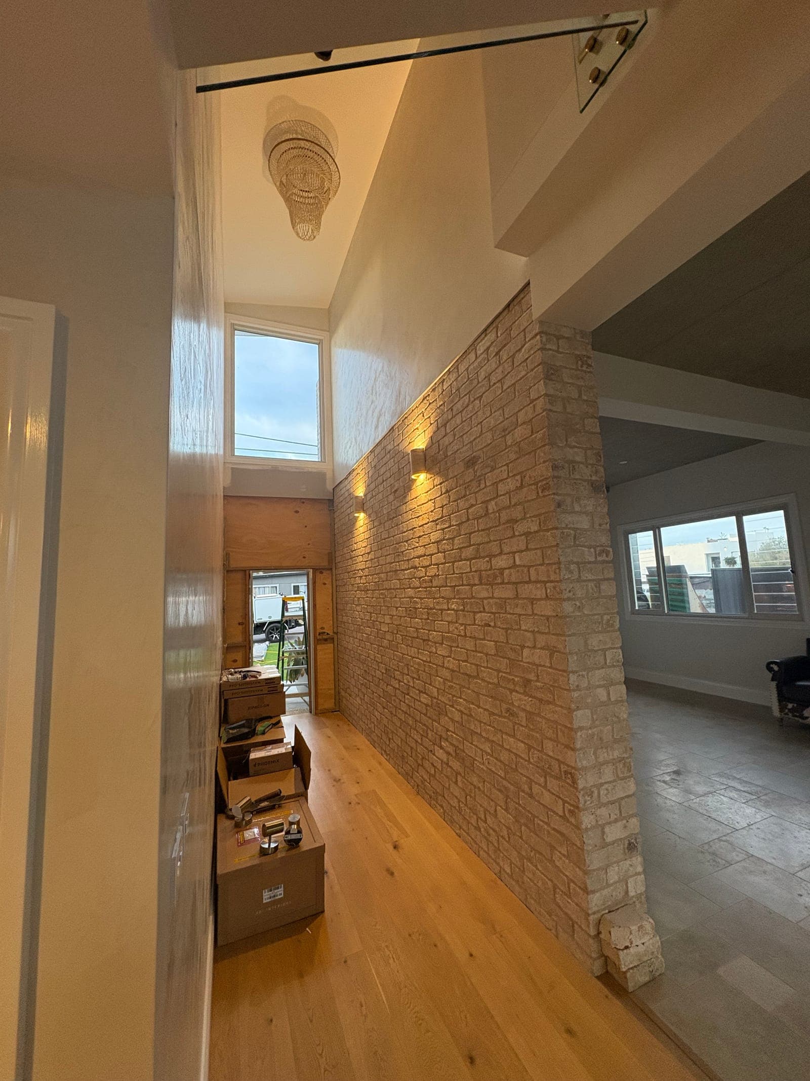 Brick feature wall lit with recessed downlights