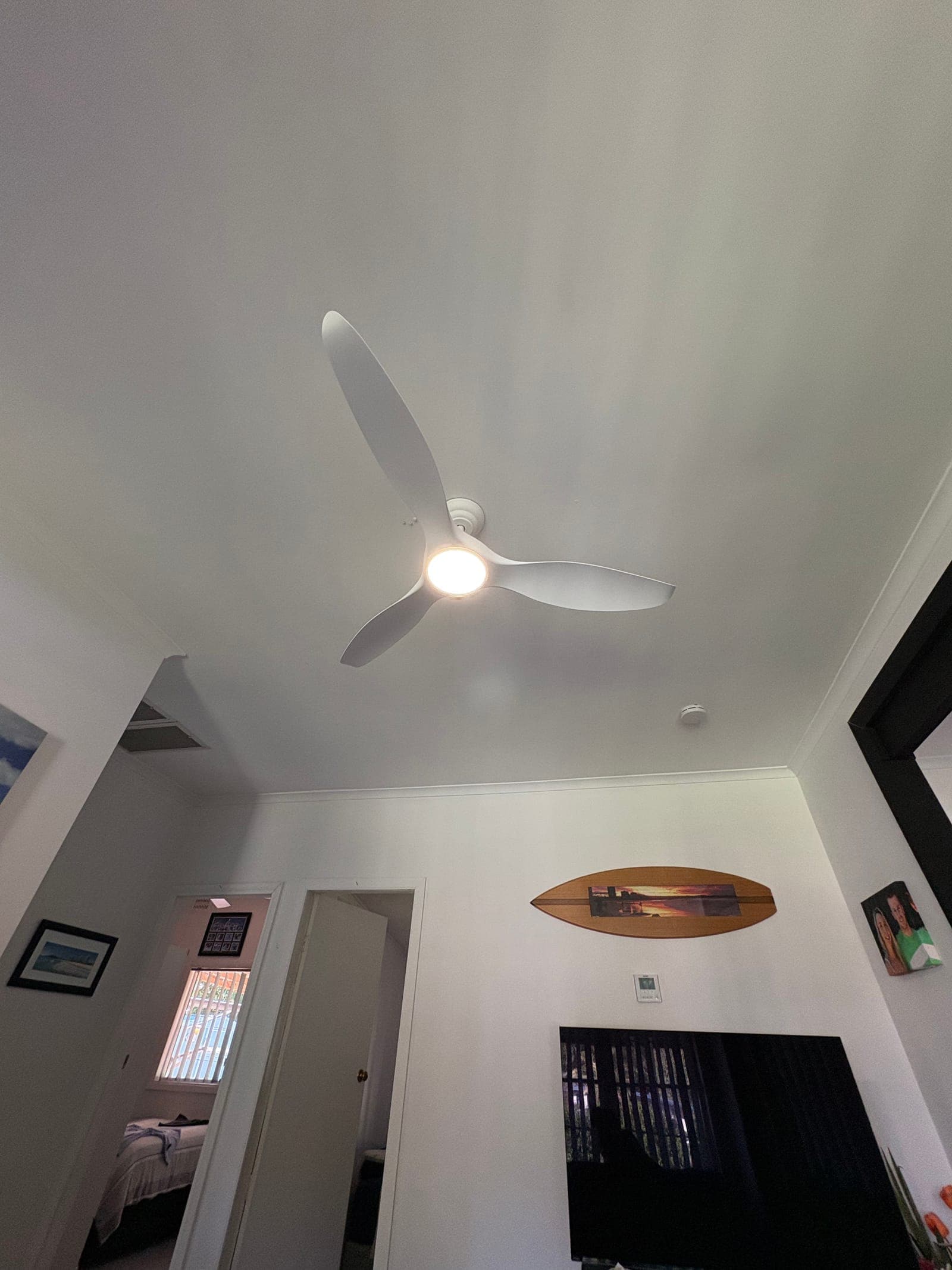 Indoor ceiling fan with integrated LED light installed in living area